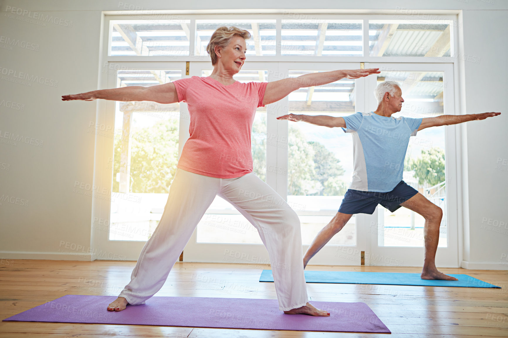 Buy stock photo Yoga, stretching and senior couple in home for fitness, health and wellness with warrior pose. Workout, mature man and woman on mat for pilates, balance and body care exercise together in retirement.