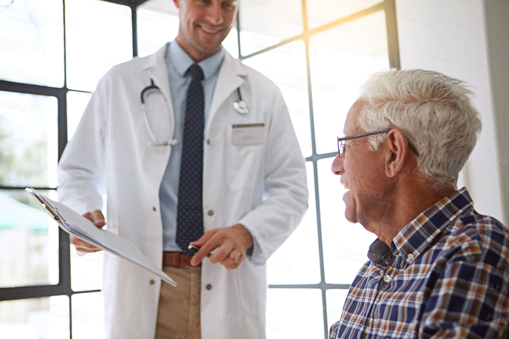 Buy stock photo Cropped shot of a male doctor talking to a senior patient in the retirement home