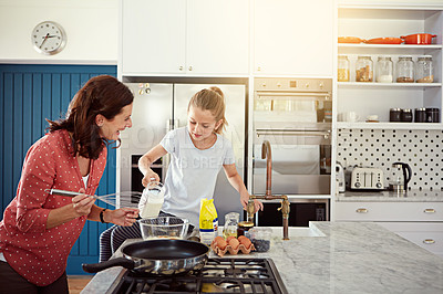 Buy stock photo Cropped shot of a mother baking with her daughter in the kitchen