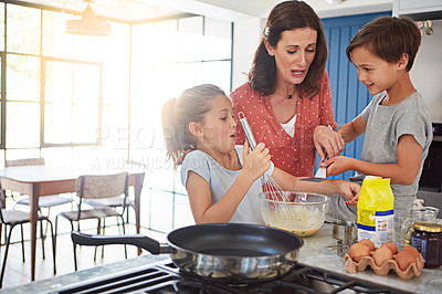 Buy stock photo Cropped shot of a mother baking with her children in the kitchen