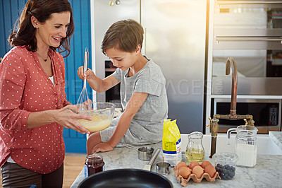 Buy stock photo Cropped shot of a mother baking with her son in the kitchen