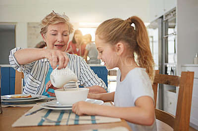 Buy stock photo Cropped shot of a little girl having breakfast with her grandmother