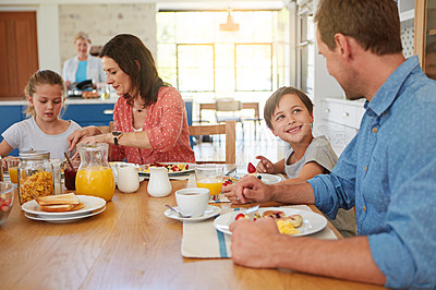 Buy stock photo Food, breakfast and weekend with a family in the dining room of their home together for health or nutrition. Mother, father and children in the morning, eating at their apartment table for bonding