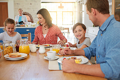 Buy stock photo Food, breakfast and love with a family in the dining room of their home together for nutrition. Portrait of a boy with his parents and sister eating at a table in an apartment for morning bonding