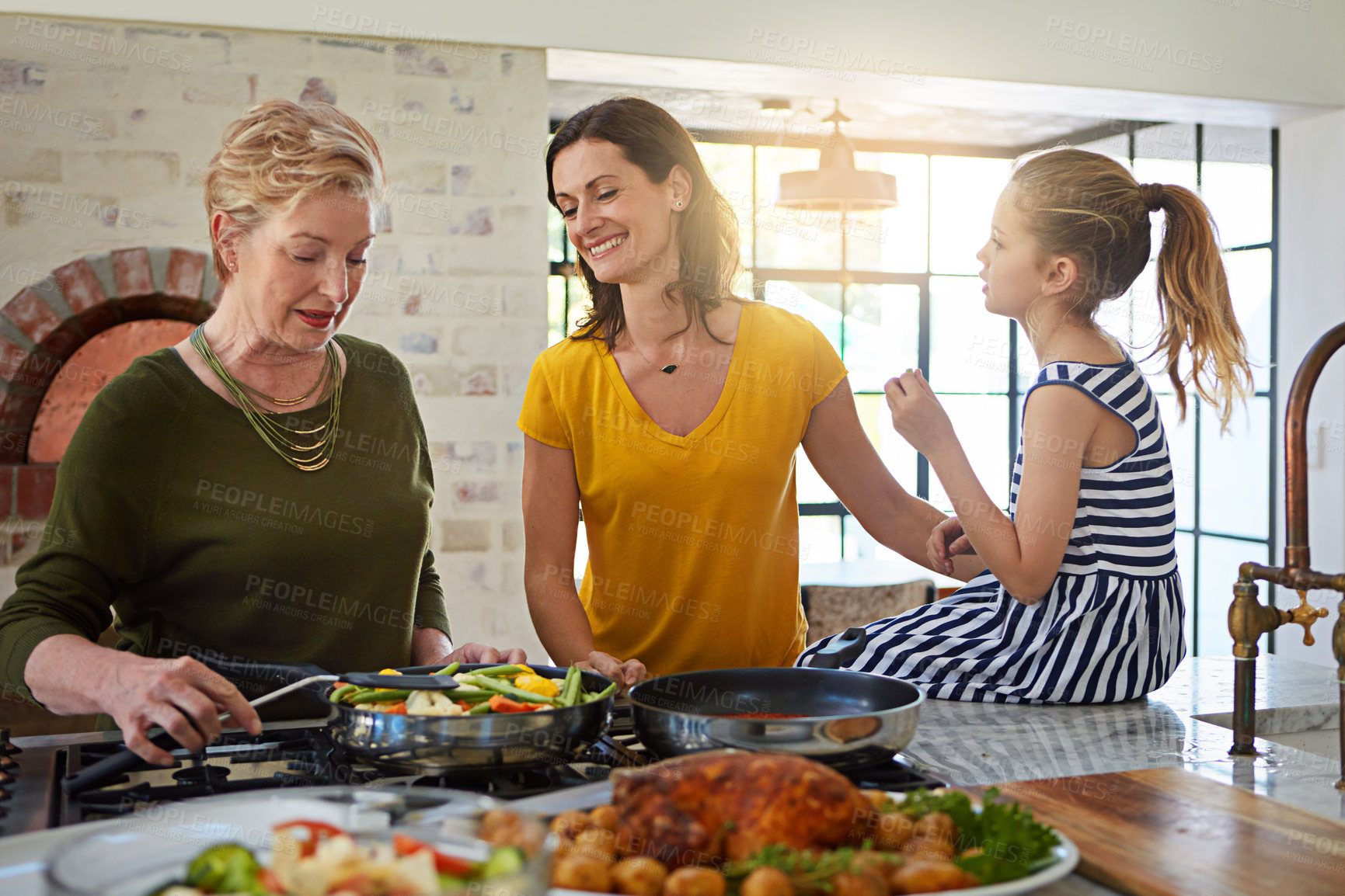Buy stock photo Shot of a three generational family of women cooking in the kitchen