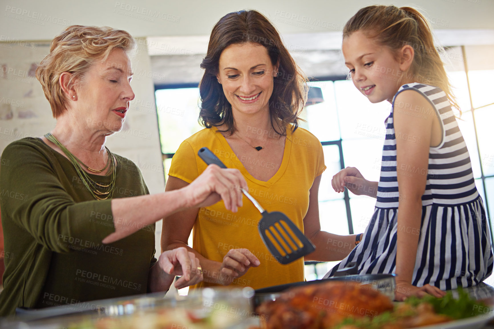 Buy stock photo Shot of a three generational family of women cooking in the kitchen