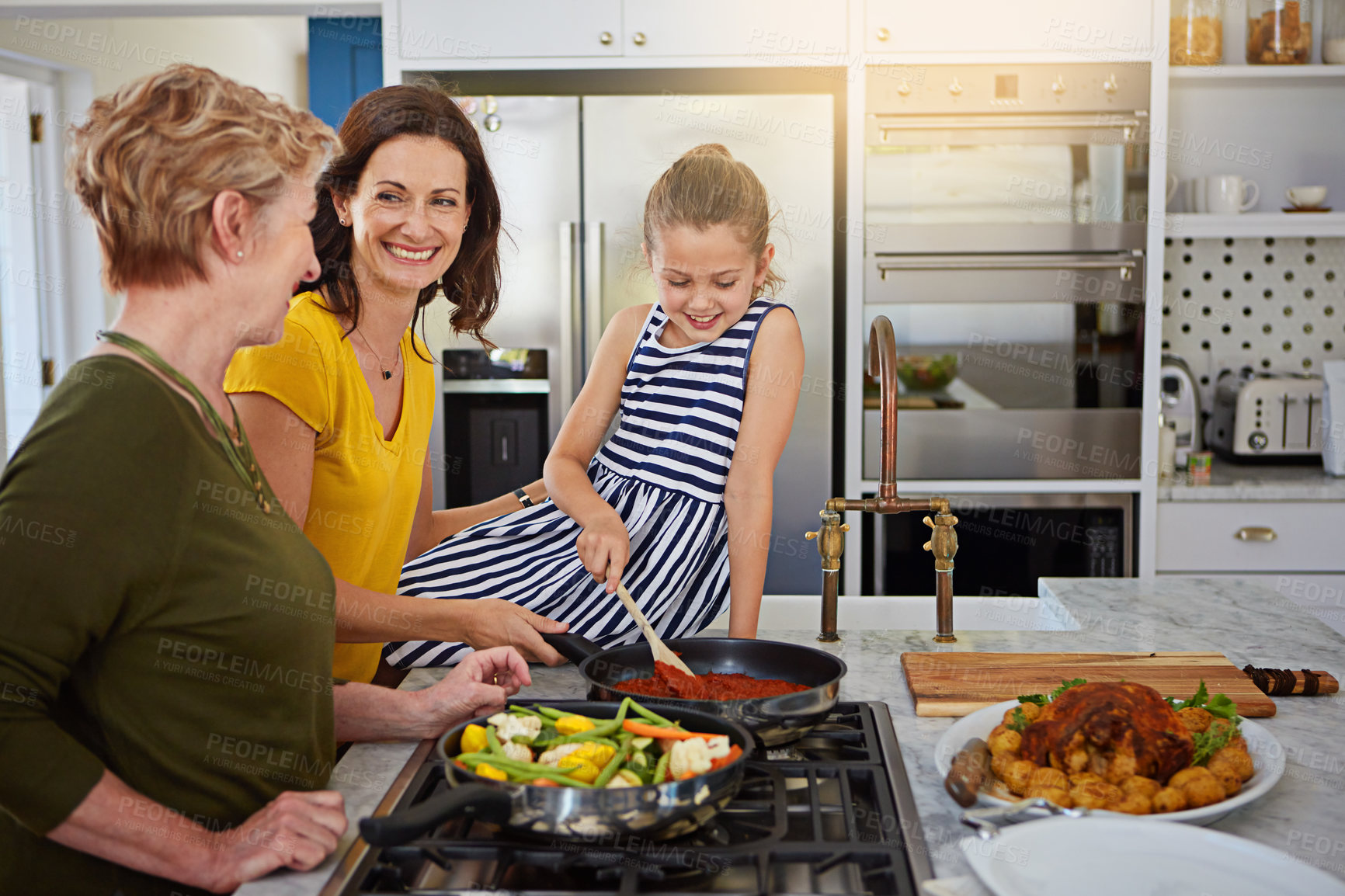 Buy stock photo Shot of a three generational family of women cooking in the kitchen