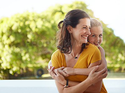 Buy stock photo Shot of a mother and daughter in a loving embrace outdoors