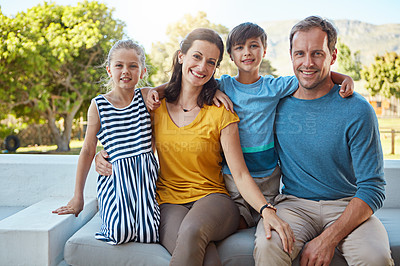 Buy stock photo Shot of a family of four spending time together in their backyard