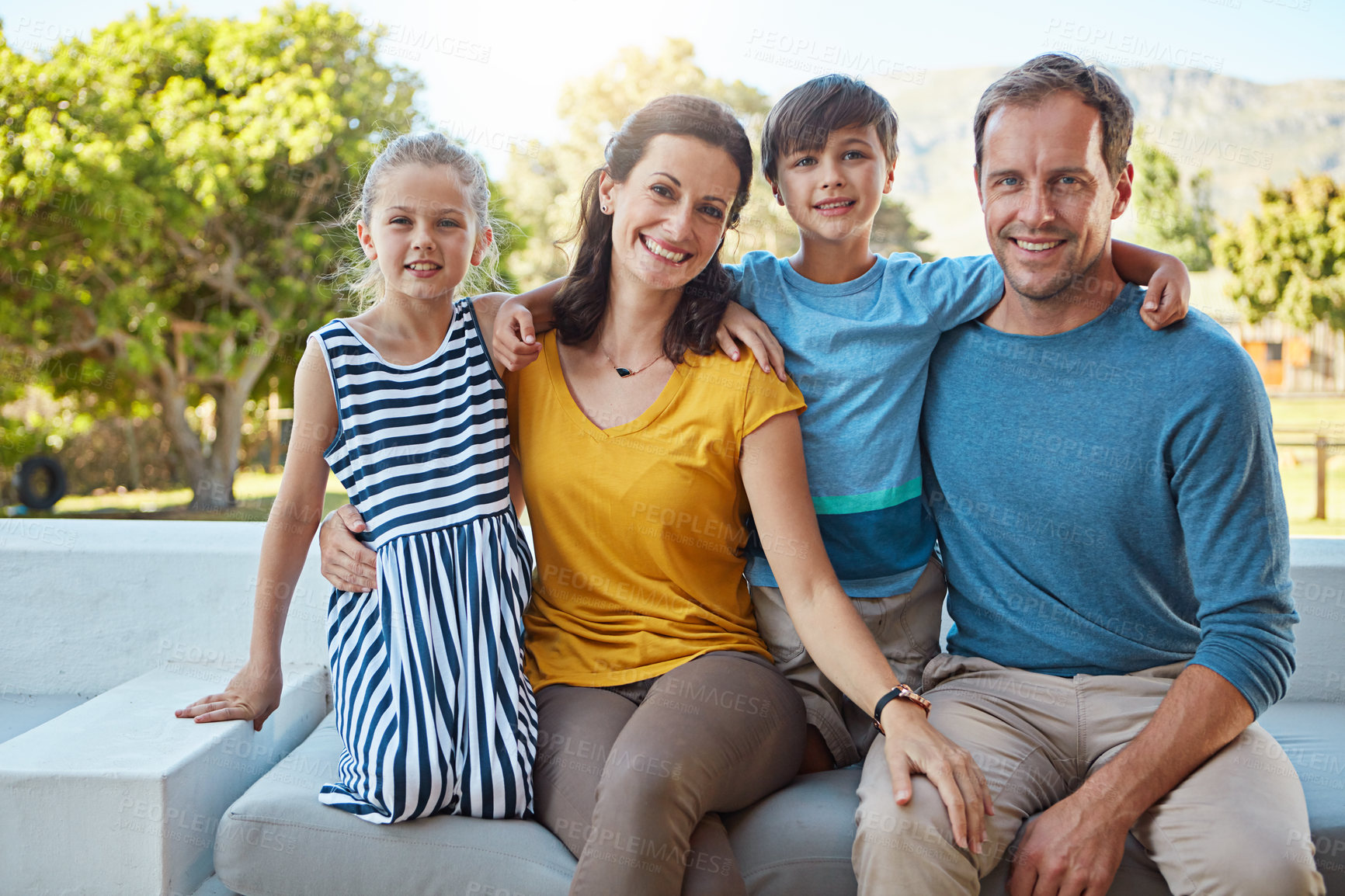 Buy stock photo Shot of a family of four spending time together in their backyard