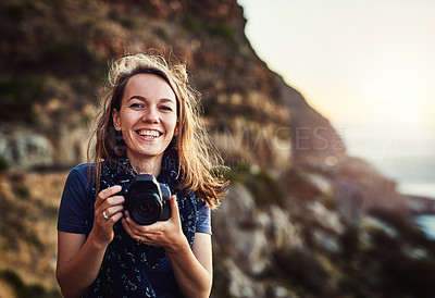 Buy stock photo Portrait of a young woman taking photos with her camera outdoors