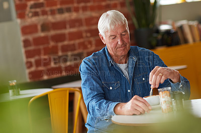 Buy stock photo Shot of a relaxed senior man enjoying a cup of coffee in a coffee shop