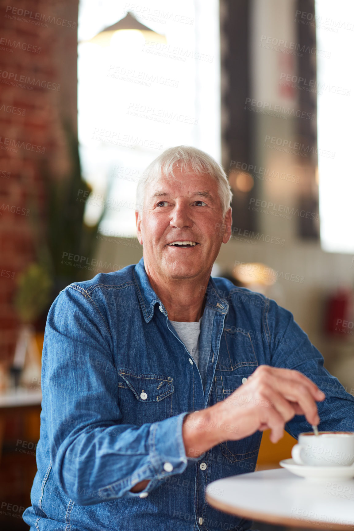 Buy stock photo Shot of a relaxed senior man enjoying a cup of coffee in a coffee shop