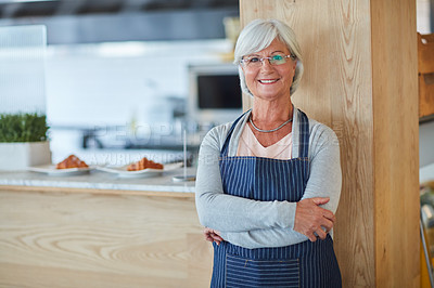 Buy stock photo Portrait of a confident senior business owner posing with an apron on in her coffee shop