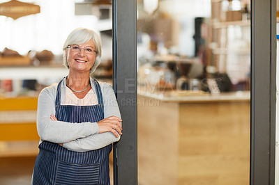 Buy stock photo Portrait of a happy senior business owner posing with her arms crossed in her coffee shop