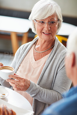 Buy stock photo Shot of a happy senior couple relaxing with a cup of coffee in a coffee shop