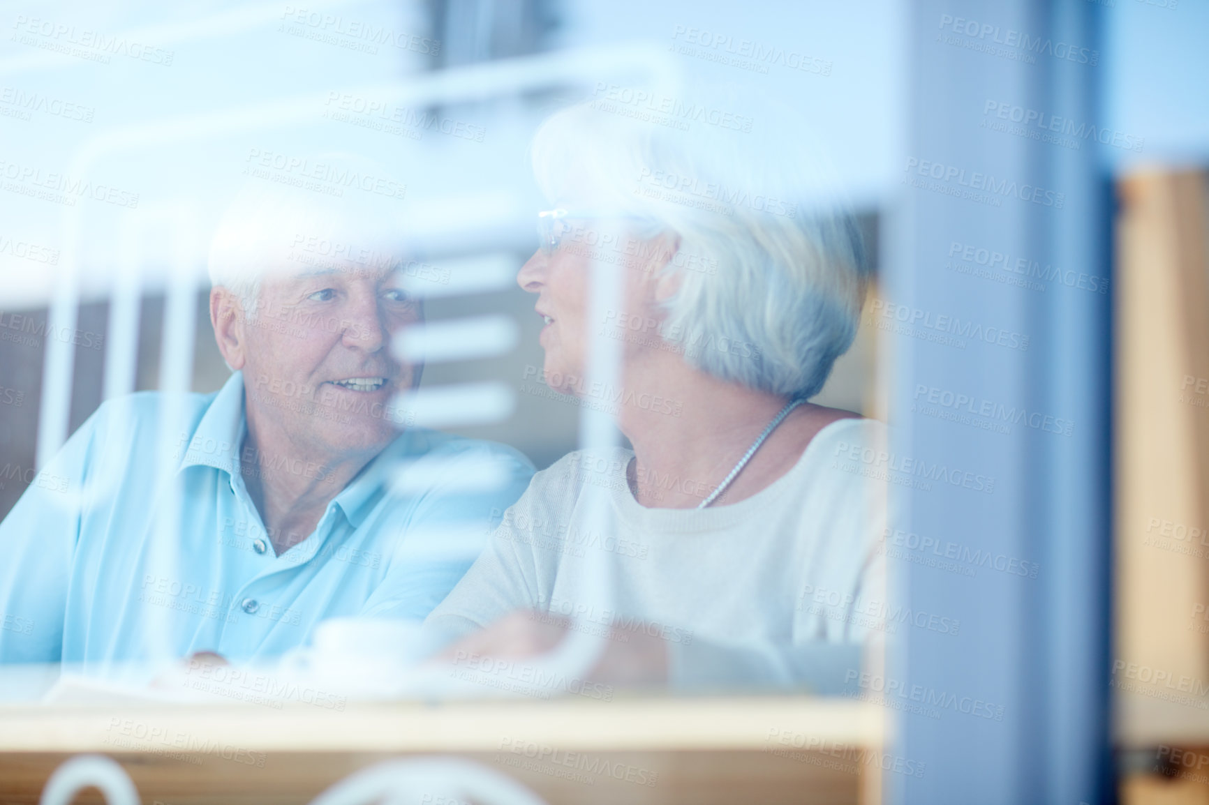 Buy stock photo Cropped shot of an affectionate senior couple in their local coffee shop