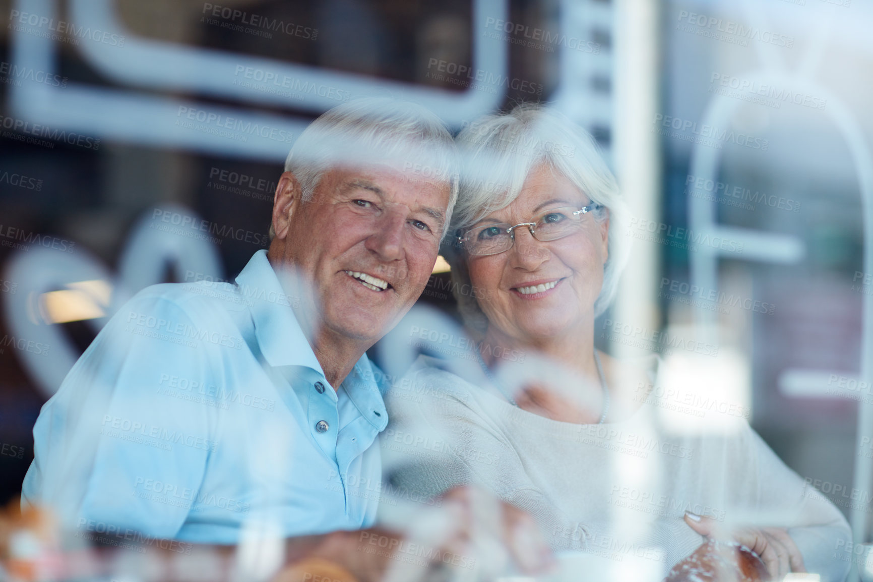 Buy stock photo Cropped portrait of an affectionate senior couple in their local coffee shop
