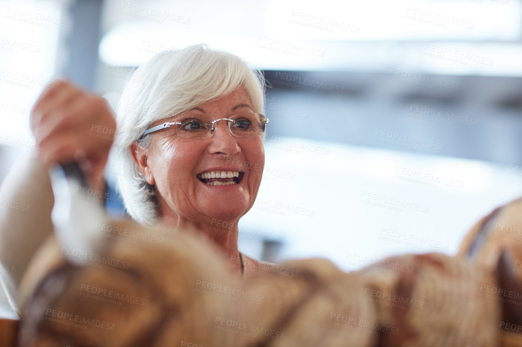 Buy stock photo Shot of a happy senior woman working in a bakery