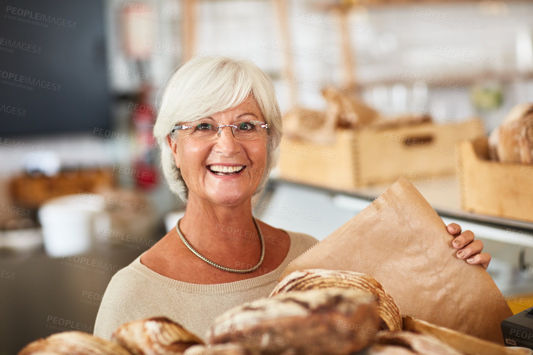 Buy stock photo Portrait of a happy senior woman working in a bakery