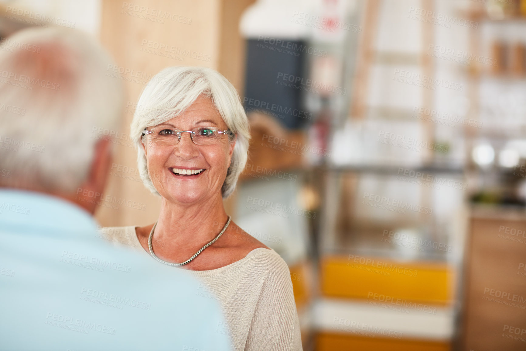 Buy stock photo Cropped shot of an affectionate senior couple in their local coffee shop