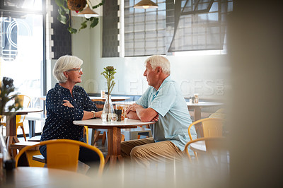 Buy stock photo Shot of a senior couple sitting in a cafe