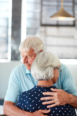 Buy stock photo Shot of a senior man embracing his wife