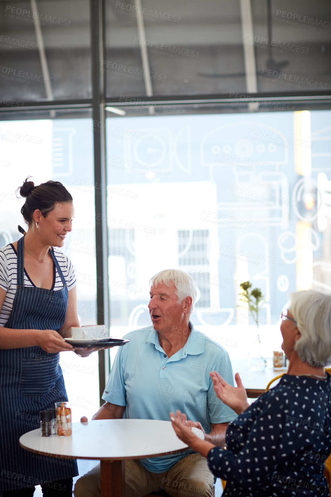 Buy stock photo Cropped shot of a senior couple being served by a waitress