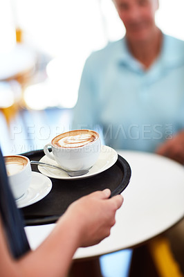 Buy stock photo Cropped shot of a waitress carrying two coffees