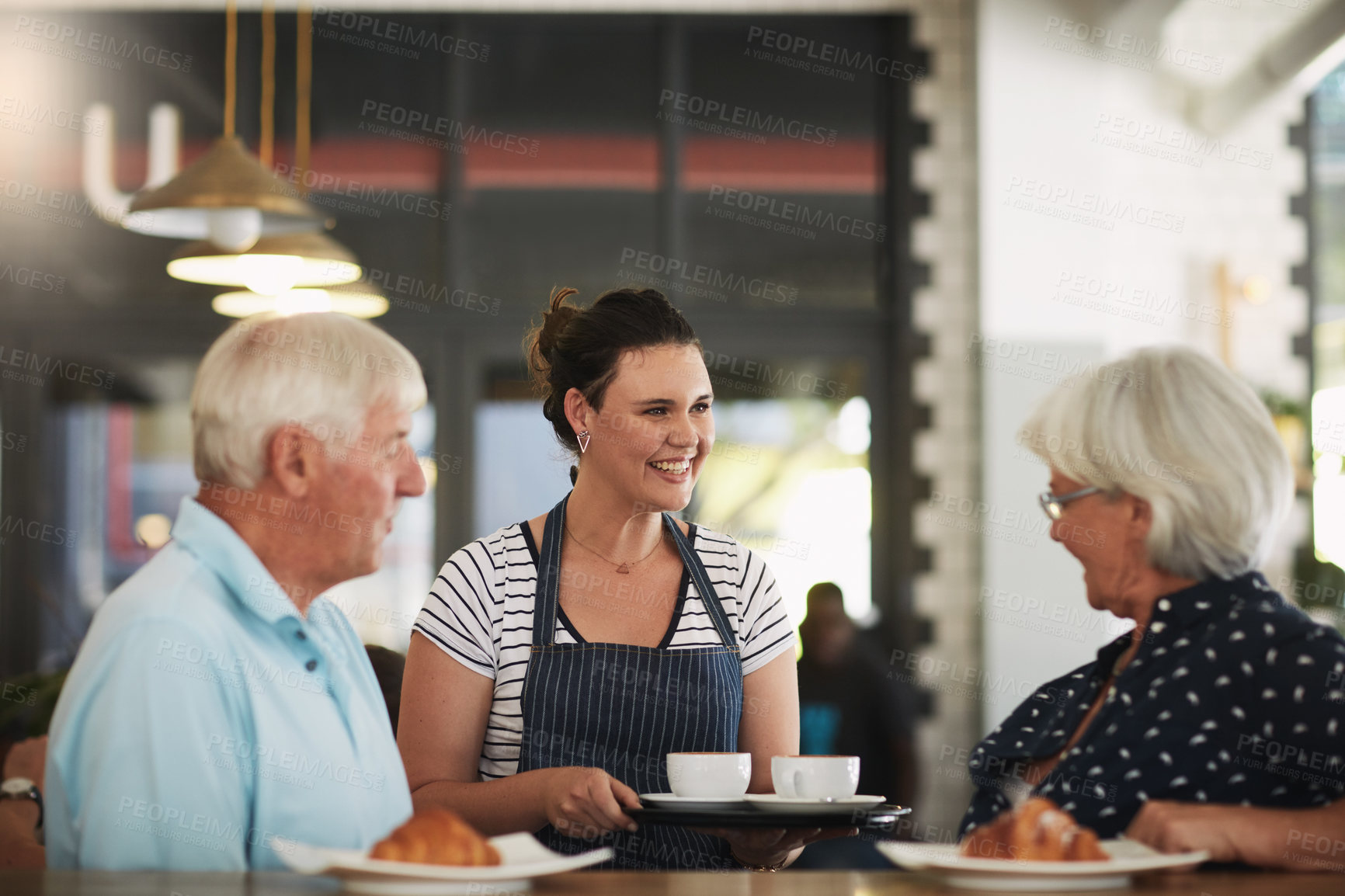 Buy stock photo Cropped shot of a senior couple being served by a waitress