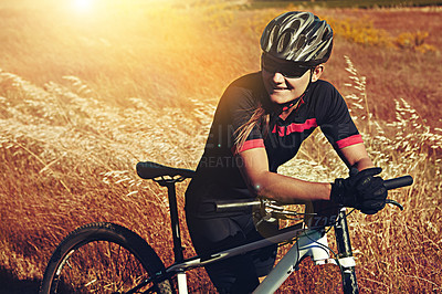 Buy stock photo Cropped shot of  an adventurous woman out cycling in the countryside