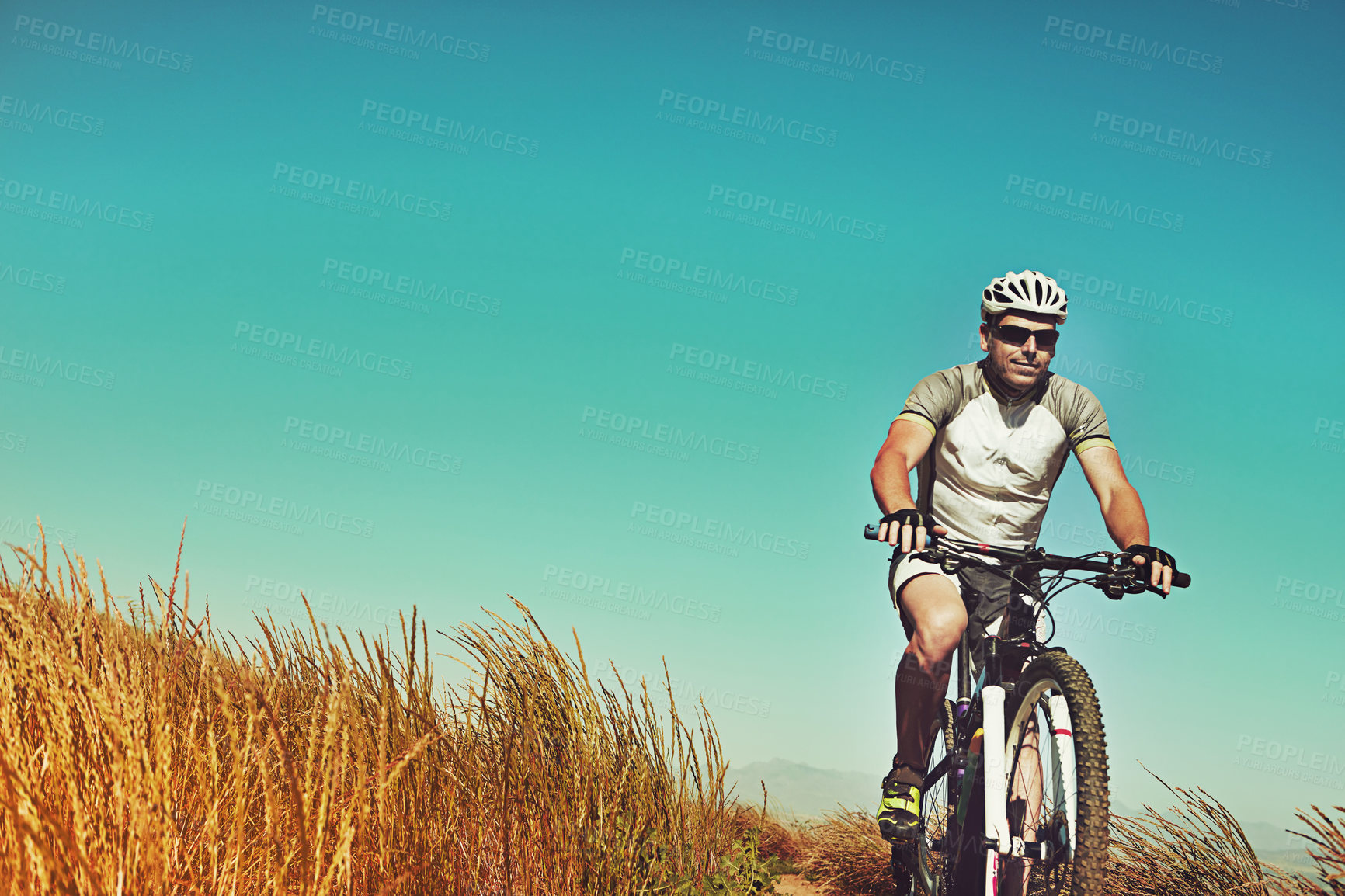 Buy stock photo Cropped shot of a man out cycling in the countryside