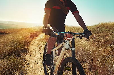 Buy stock photo Cropped shot of  an adventurous woman out cycling in the countryside