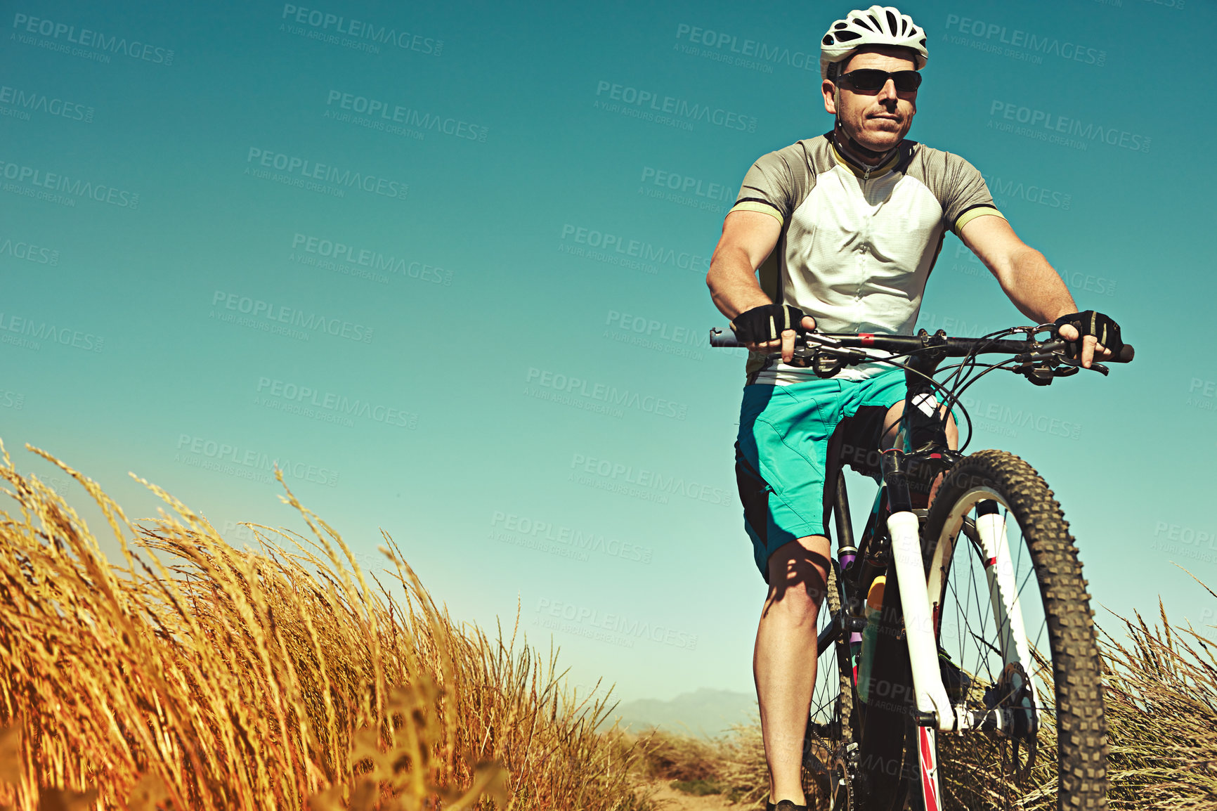 Buy stock photo Cropped shot of a man out cycling in the countryside