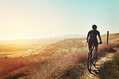 Buy stock photo Cropped shot of  an adventurous woman out cycling in the countryside