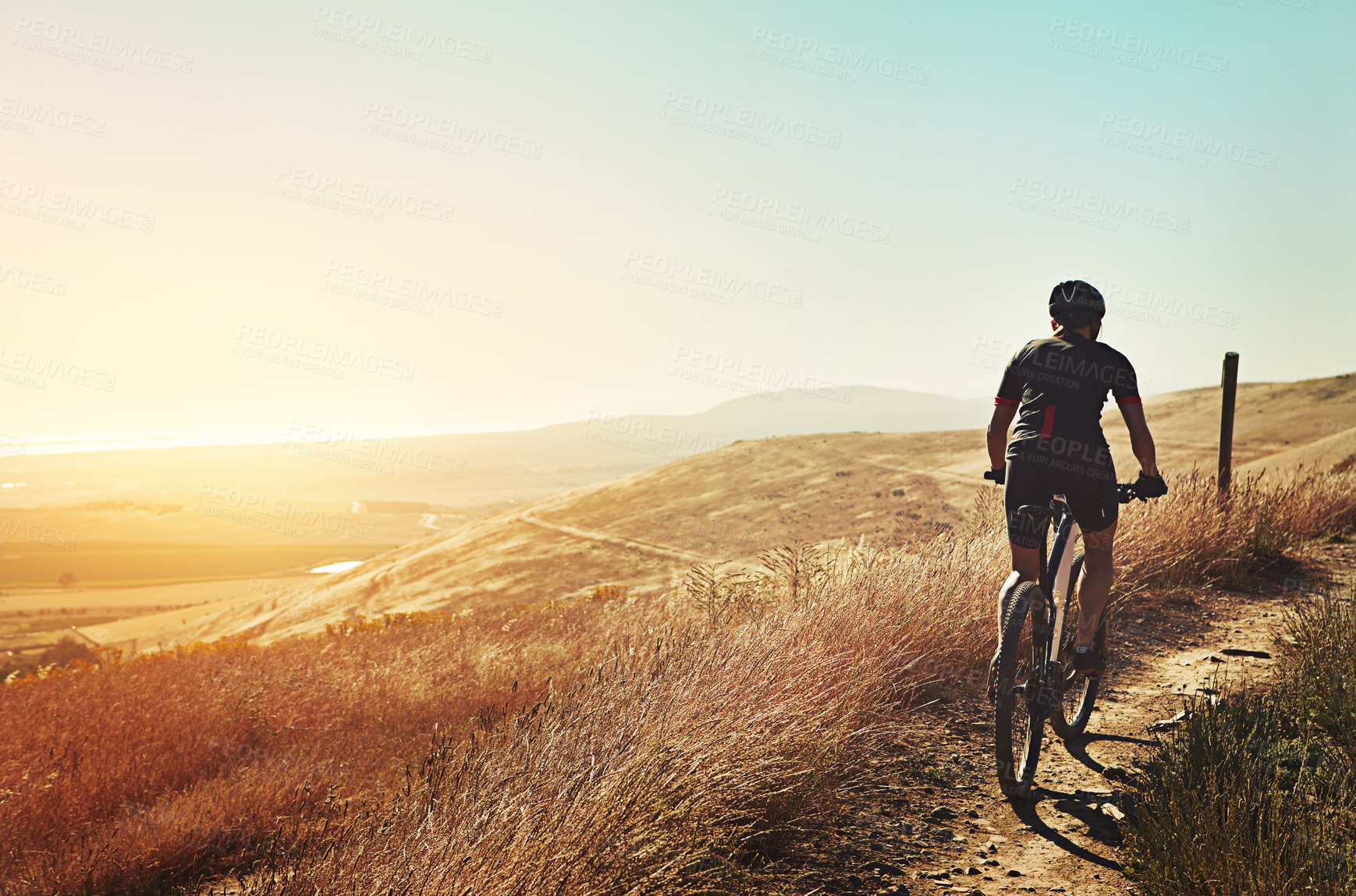 Buy stock photo Cropped shot of  an adventurous woman out cycling in the countryside