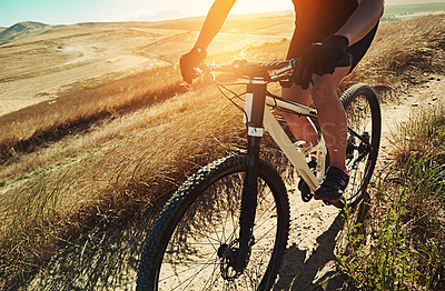 Buy stock photo Cropped shot of  an adventurous woman out cycling in the countryside