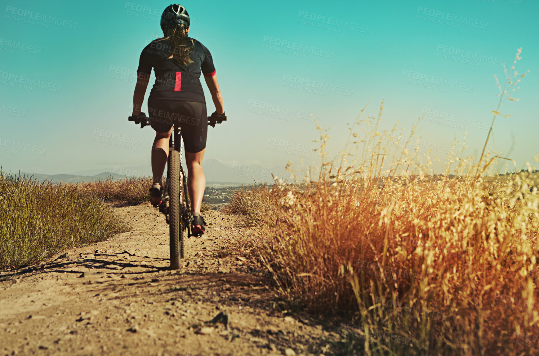 Buy stock photo Cropped shot of  an adventurous woman out cycling in the countryside