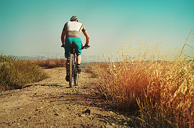 Buy stock photo Cropped shot of a man out cycling in the countryside