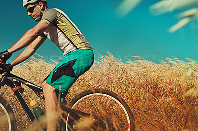 Buy stock photo Cropped shot of a man out cycling in the countryside