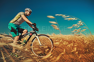 Buy stock photo Cropped shot of a man out cycling in the countryside