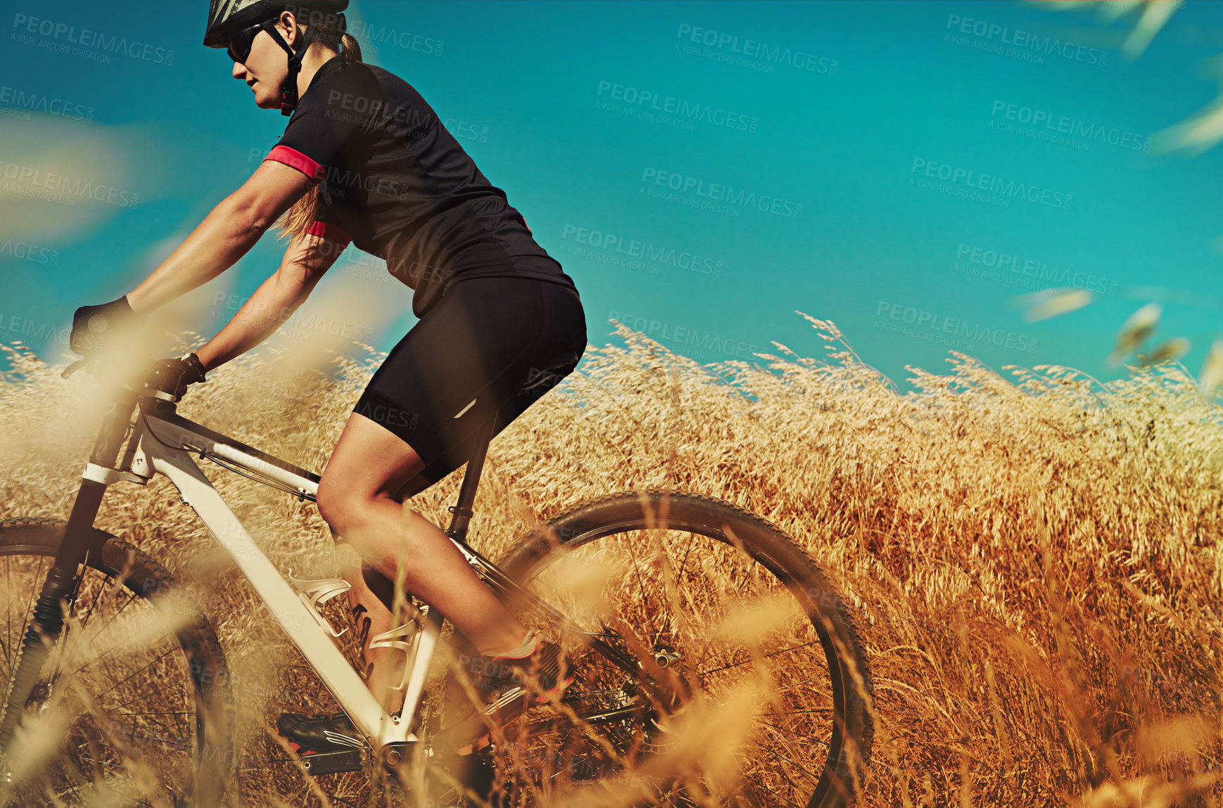 Buy stock photo Cropped shot of  an adventurous woman out cycling in the countryside