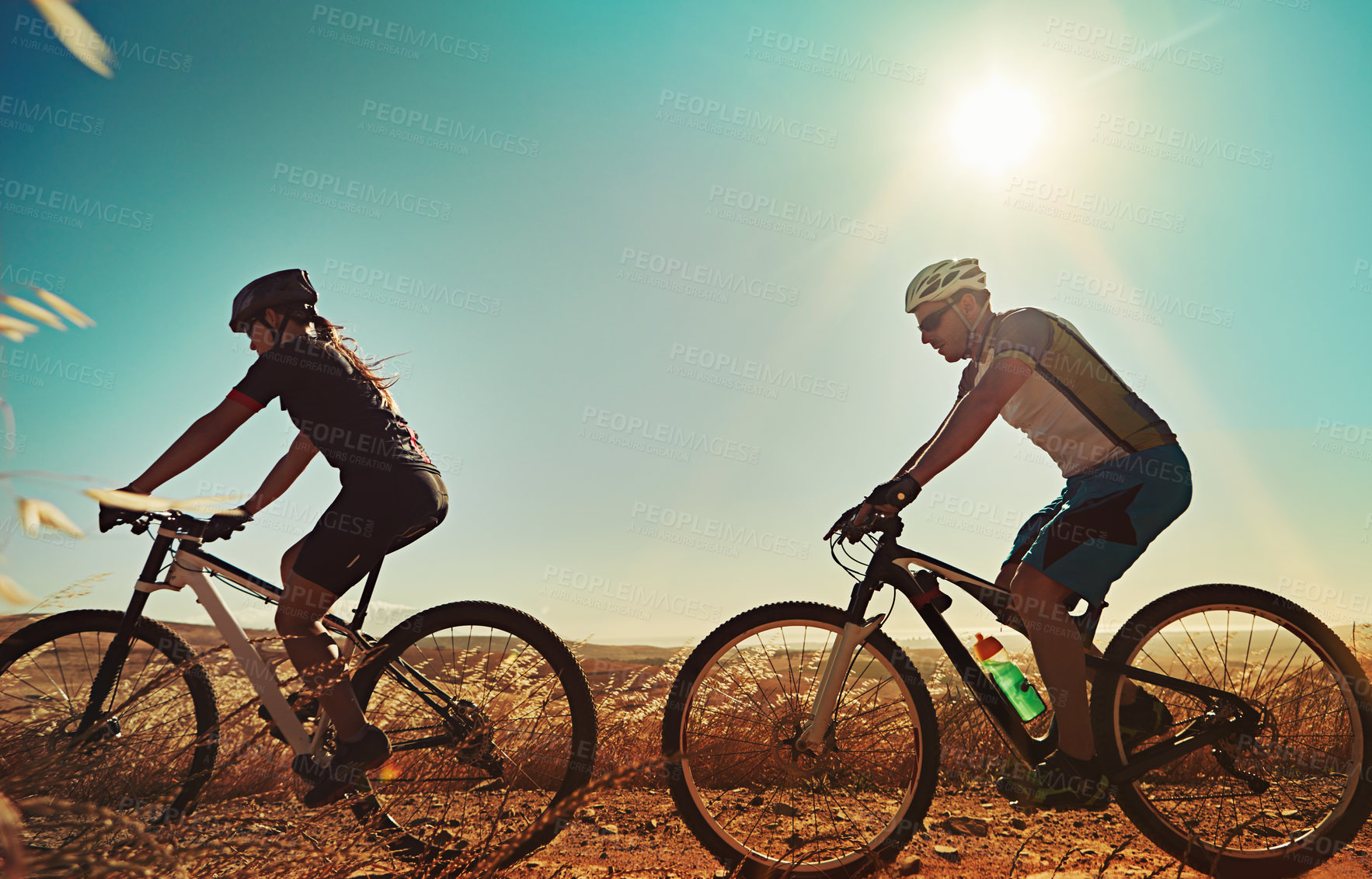 Buy stock photo Shot of two cyclists out cycling in the countryside