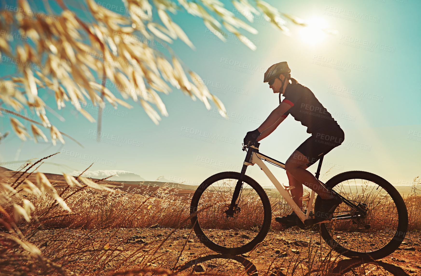 Buy stock photo Cropped shot of  an adventurous woman out cycling in the countryside