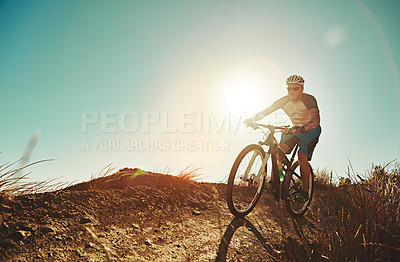 Buy stock photo Cropped shot of a man out cycling in the countryside