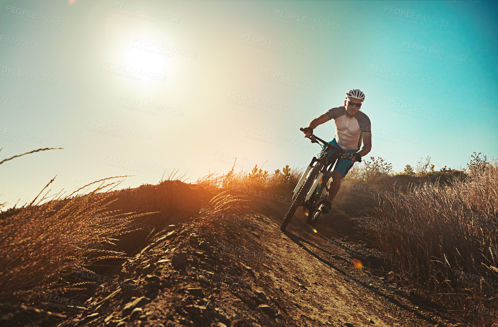 Buy stock photo Cropped shot of a man out cycling in the countryside