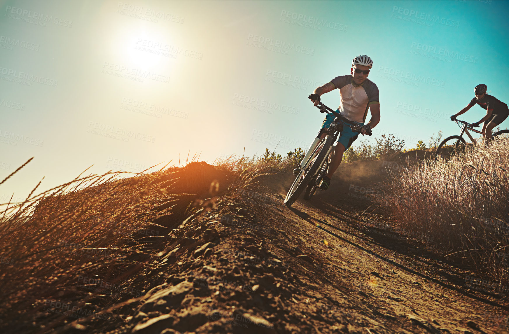 Buy stock photo Shot of two cyclists out cycling in the countryside