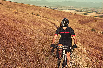 Buy stock photo Cropped shot of  an adventurous woman out cycling in the countryside