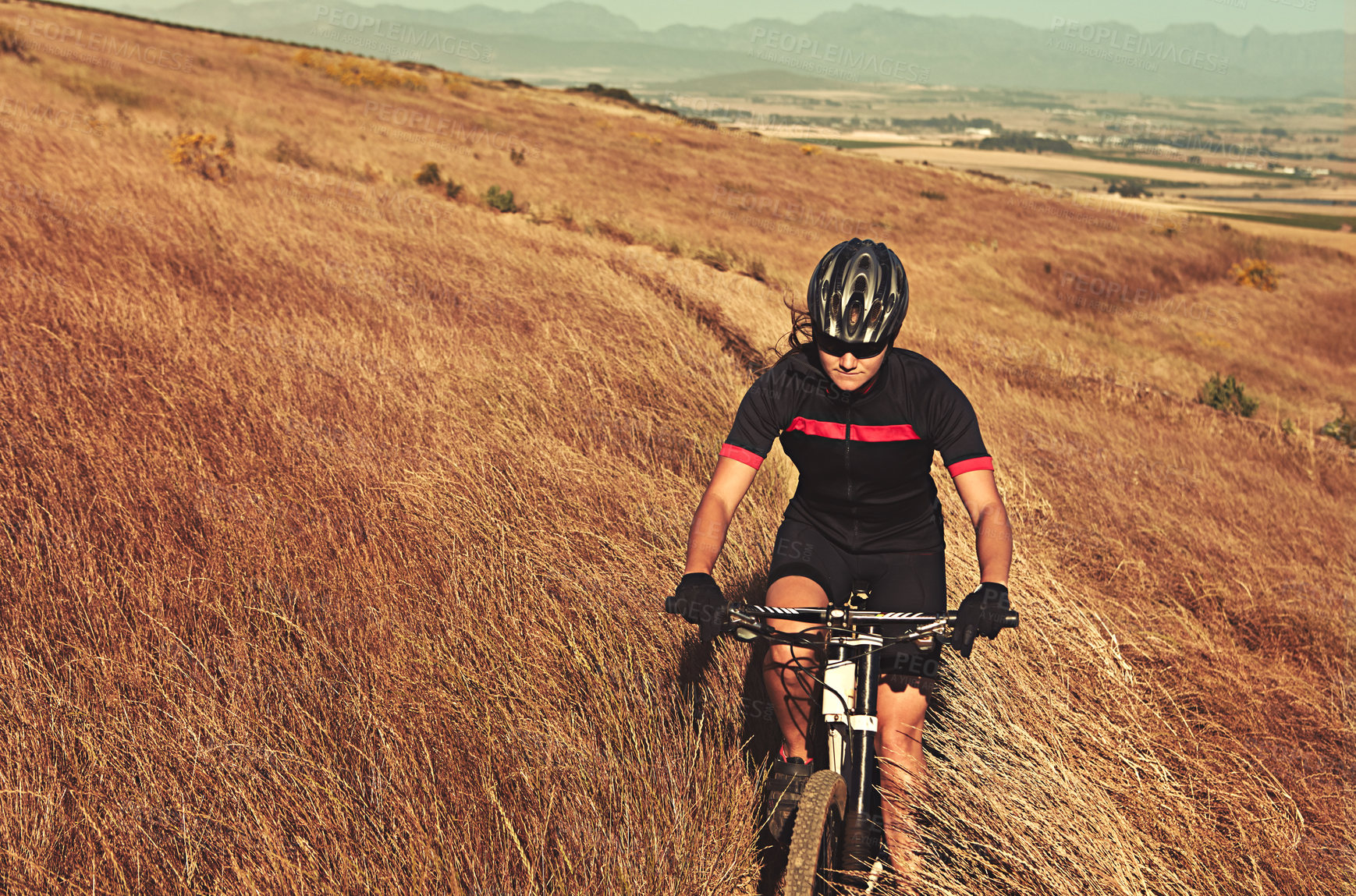 Buy stock photo Cropped shot of  an adventurous woman out cycling in the countryside