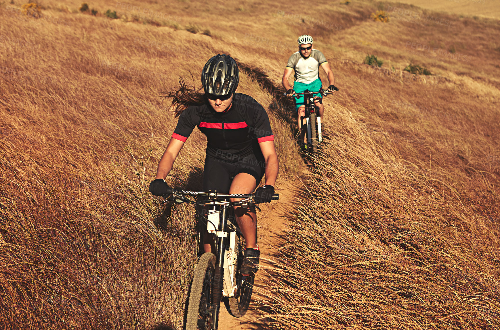 Buy stock photo Shot of two cyclists out cycling in the countryside